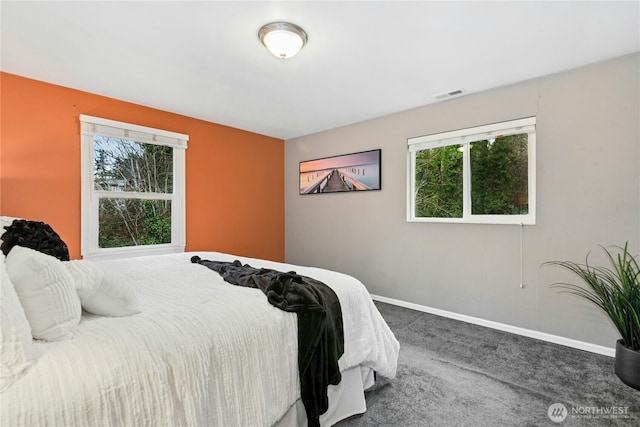 carpeted bedroom featuring visible vents and baseboards