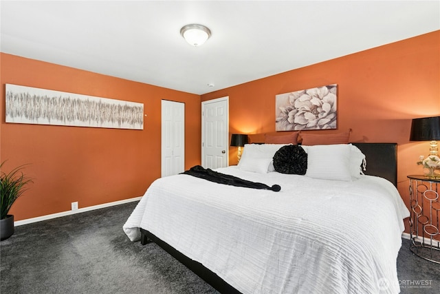 carpeted bedroom featuring a closet and baseboards