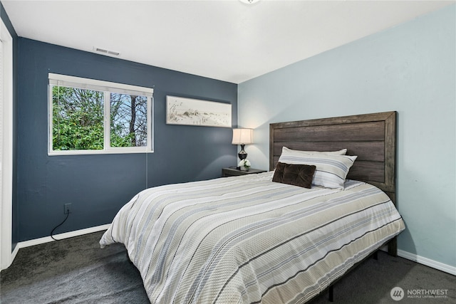 bedroom with carpet floors, visible vents, and baseboards