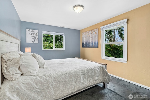 carpeted bedroom with visible vents and baseboards