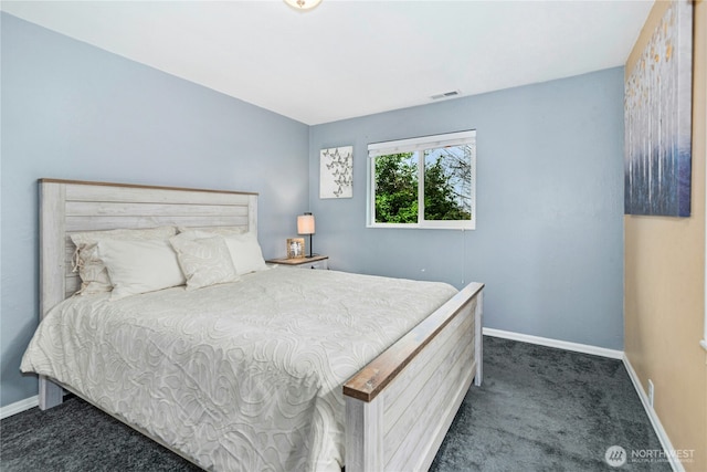 bedroom with visible vents, dark carpet, and baseboards