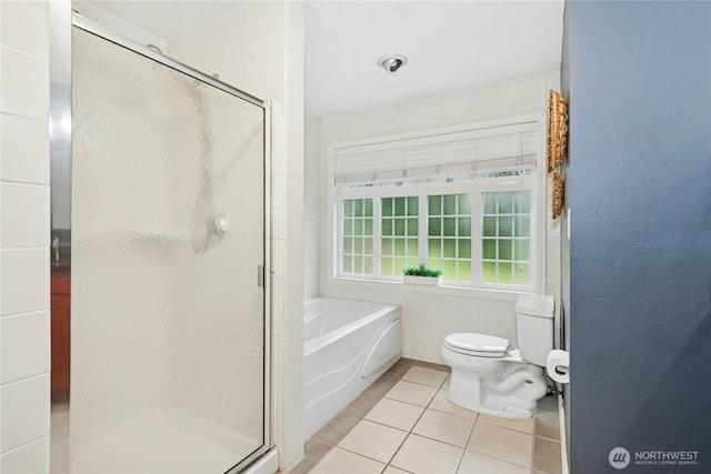 bathroom with toilet, a shower stall, a bath, and tile patterned floors