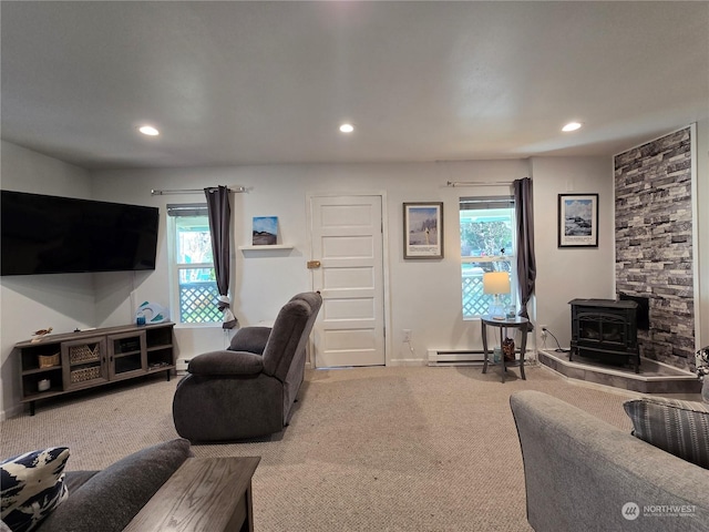 carpeted living room featuring a wood stove and baseboard heating