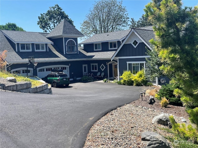 8259 Kaster Dr NE, Bremerton, WA 98311 - view of front facade with driveway, board and batten siding, and an attached garage