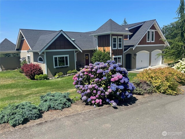 8259 Kaster Dr NE, Bremerton, WA 98311 - craftsman inspired home featuring board and batten siding, a front lawn, a garage, and a shingled roof
