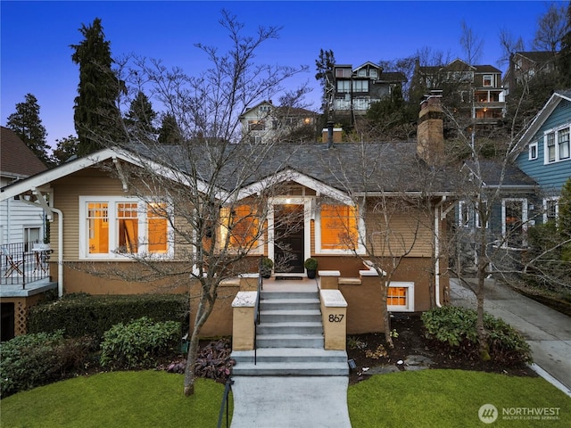 view of front of house with a front yard and stucco siding