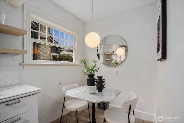 dining room with baseboards and tile patterned floors