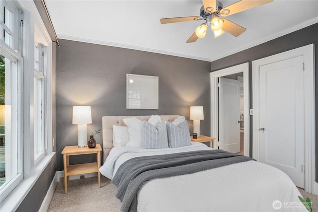 bedroom with ornamental molding, carpet floors, baseboards, and a ceiling fan