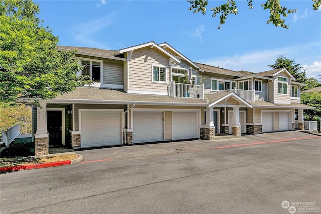 view of front of property featuring a garage and central AC