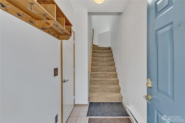 stairway featuring tile patterned flooring and a baseboard heating unit