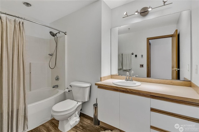 full bathroom with hardwood / wood-style flooring, vanity, toilet, and shower / tub combo