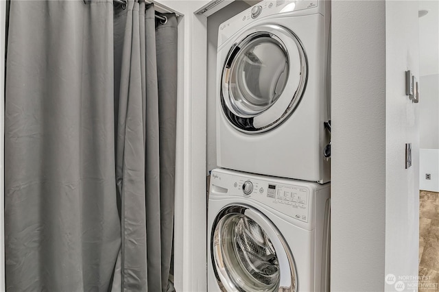 washroom with stacked washer and dryer