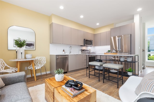 living room with sink and light hardwood / wood-style floors