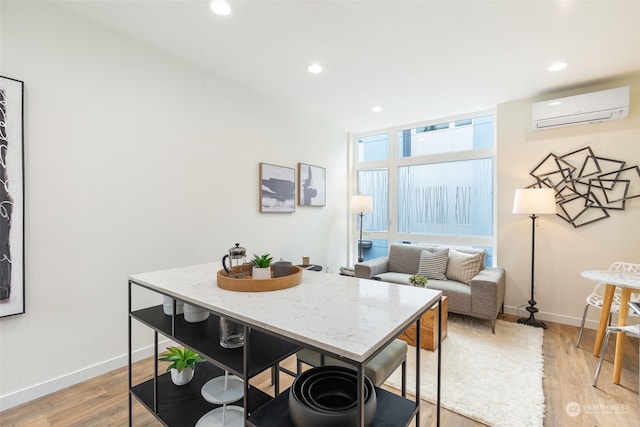 dining space featuring light hardwood / wood-style floors and an AC wall unit