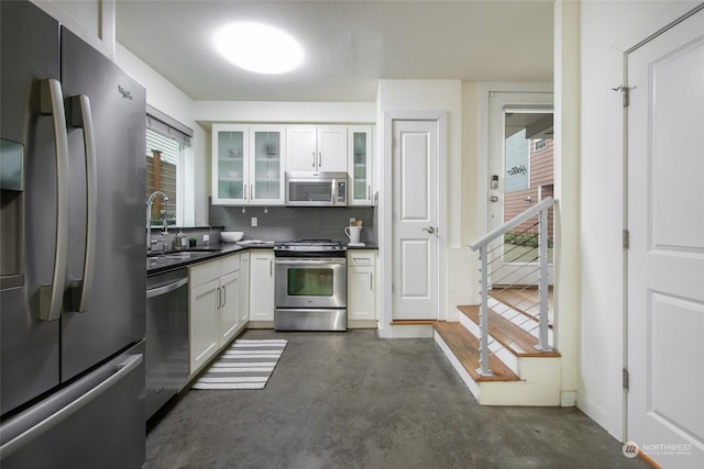 kitchen with white cabinetry, appliances with stainless steel finishes, sink, and tasteful backsplash