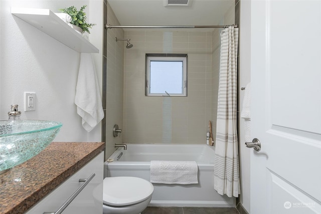 full bathroom featuring vanity, shower / bath combo, and toilet