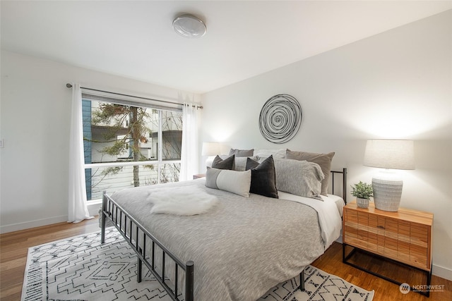 bedroom with wood-type flooring