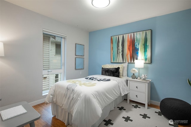 bedroom featuring multiple windows and light hardwood / wood-style floors