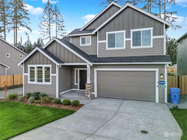 craftsman house with a garage and a front lawn