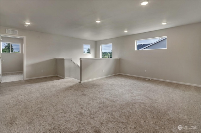 unfurnished room featuring light carpet