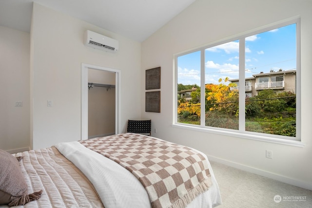 bedroom featuring vaulted ceiling, an AC wall unit, carpet flooring, and a closet