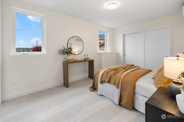 carpeted bedroom with a closet