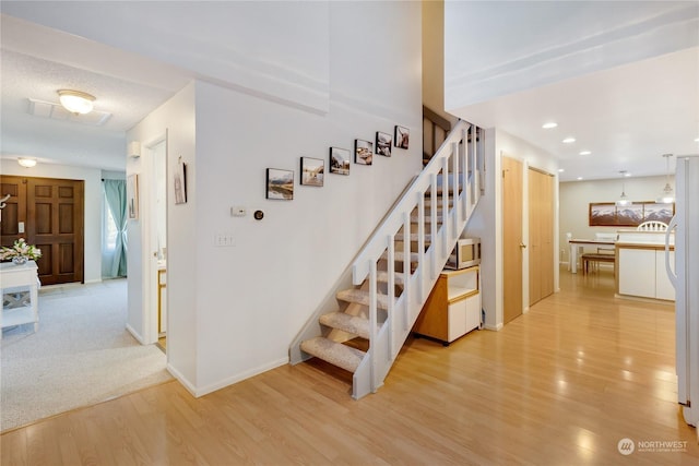 stairway featuring hardwood / wood-style floors