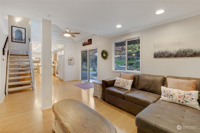 living room with light hardwood / wood-style floors and ceiling fan