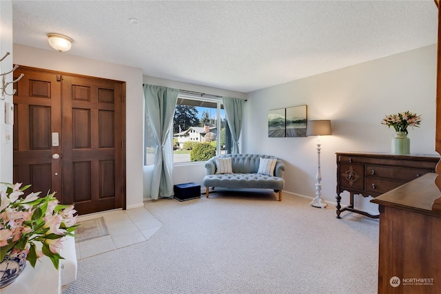 carpeted entrance foyer featuring a textured ceiling