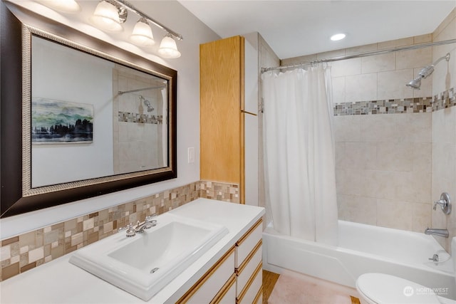 full bathroom with decorative backsplash, vanity, shower / bath combination with curtain, and toilet