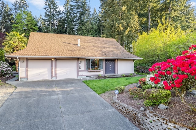 9230 119th St E, Puyallup, WA 98373 - view of front of home with a shingled roof, a garage, crawl space, a front yard, and driveway