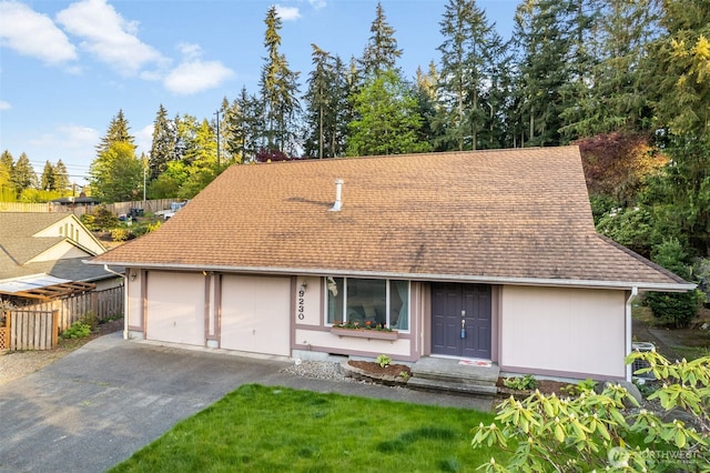 9230 119th St E, Puyallup, WA 98373 - view of front of house with an attached garage, roof with shingles, fence, and driveway