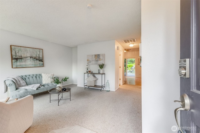 9230 119th St E, Puyallup, WA 98373 - living room featuring a textured ceiling, visible vents, baseboards, and carpet