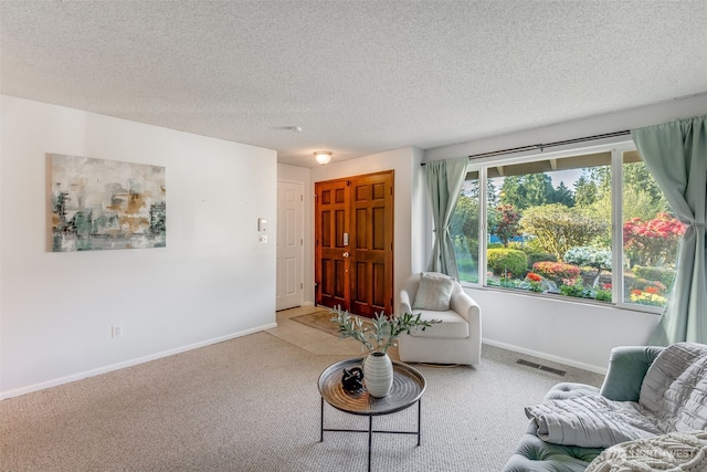 9230 119th St E, Puyallup, WA 98373 - living area featuring visible vents, a textured ceiling, carpet, and baseboards