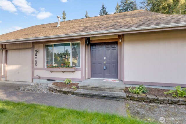 9230 119th St E, Puyallup, WA 98373 - doorway to property with roof with shingles and a garage