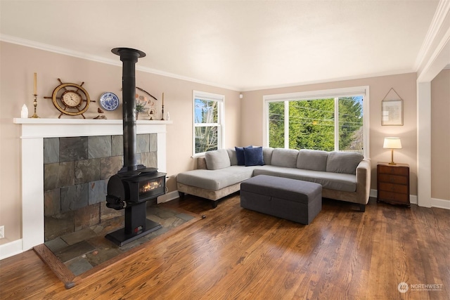 living room featuring crown molding, a healthy amount of sunlight, dark hardwood / wood-style flooring, and a wood stove