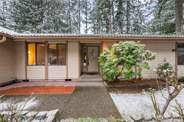 property entrance featuring a patio