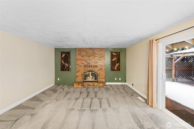 unfurnished living room with a fireplace, a textured ceiling, and carpet