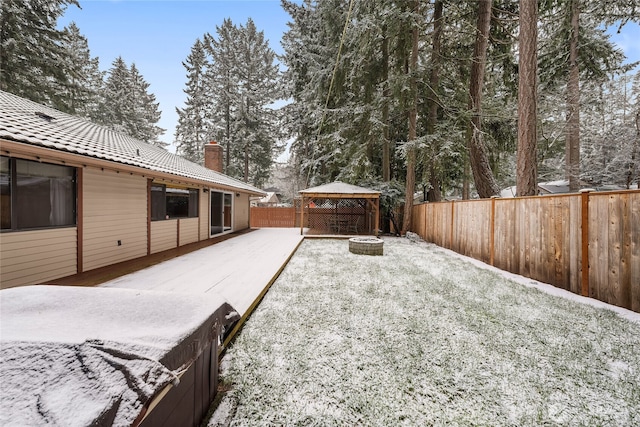 snowy yard with a gazebo and a fire pit