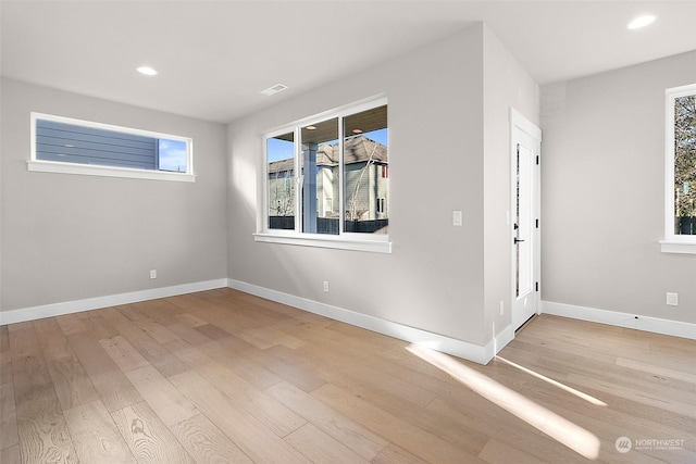 empty room with light hardwood / wood-style floors