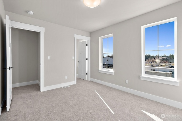 unfurnished bedroom featuring light colored carpet