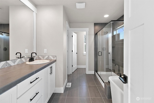 bathroom with vanity, a shower with shower door, and tile patterned flooring