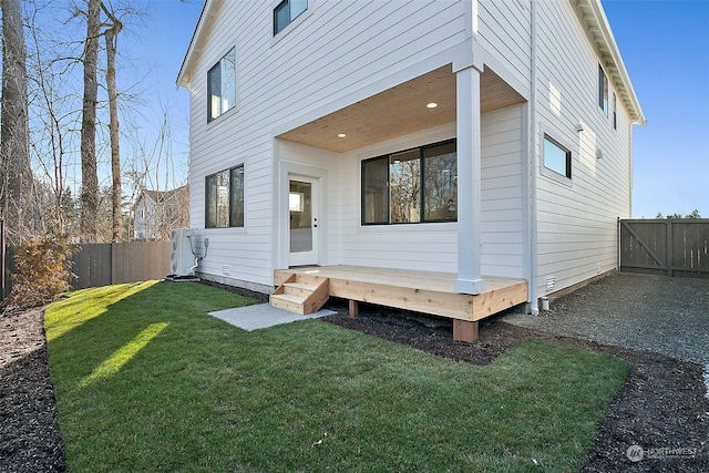 rear view of house featuring a lawn