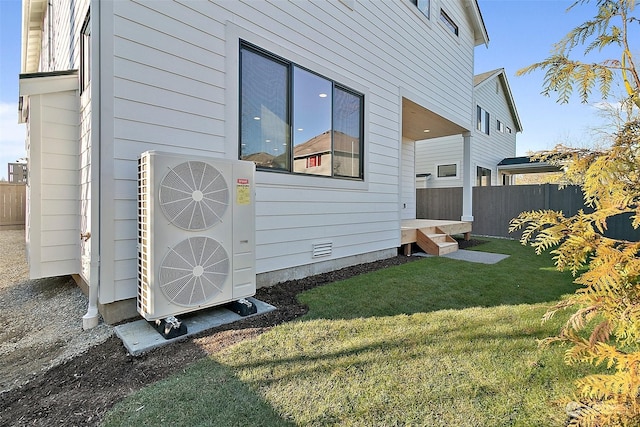 exterior space with ac unit and a yard