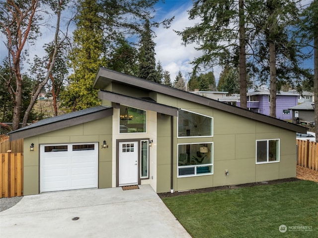 view of front of house with a garage and a front lawn