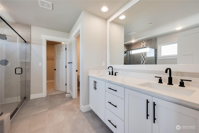 bathroom with vanity, tile patterned floors, toilet, and walk in shower