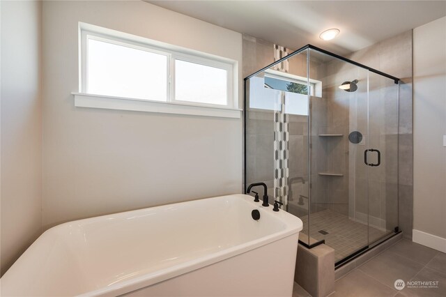 bathroom featuring separate shower and tub and tile patterned floors