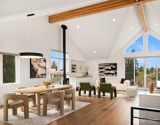 interior space featuring hardwood / wood-style flooring, beamed ceiling, and high vaulted ceiling