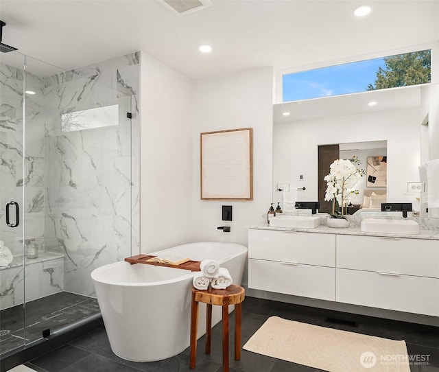 bathroom featuring separate shower and tub and vanity