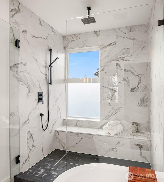 bathroom featuring shower with separate bathtub